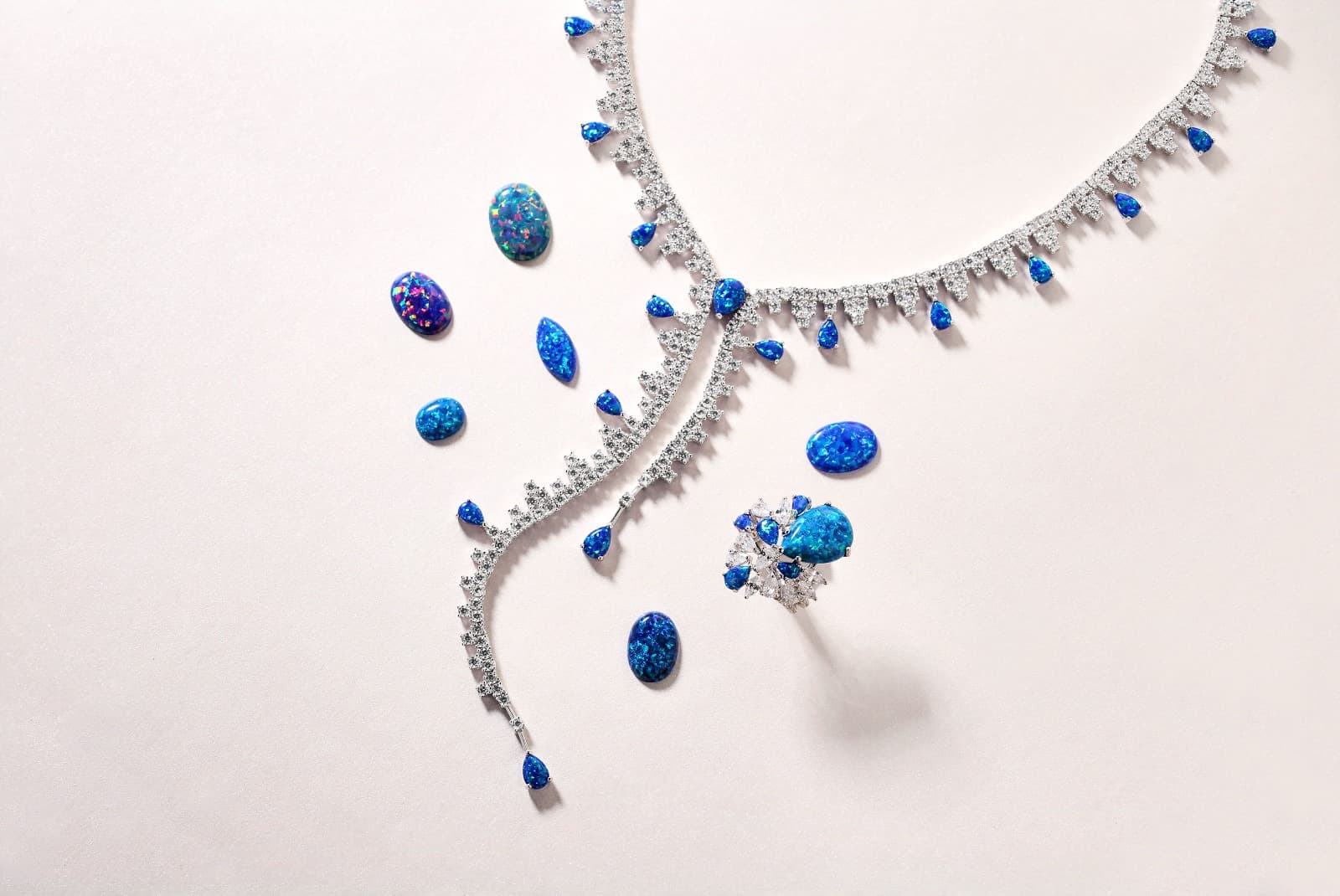 Bello Opal blue synthetic opal jewelry showcasing vivid play-of-color iridescence