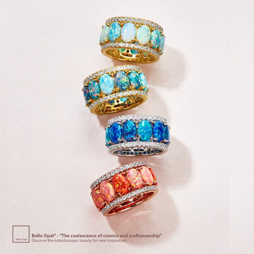 Four Bello Opal eternity rings in white, green, blue, and orange lab-grown opals with pavé borders